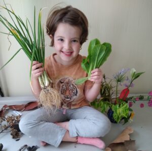 Young Girl with Harvested Vegetables from the Vegtable Garden